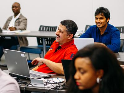 Students laughing at computers